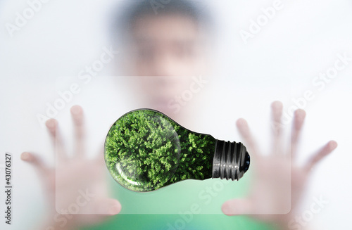 Man benind the screen and green bulb for green eco concept photo