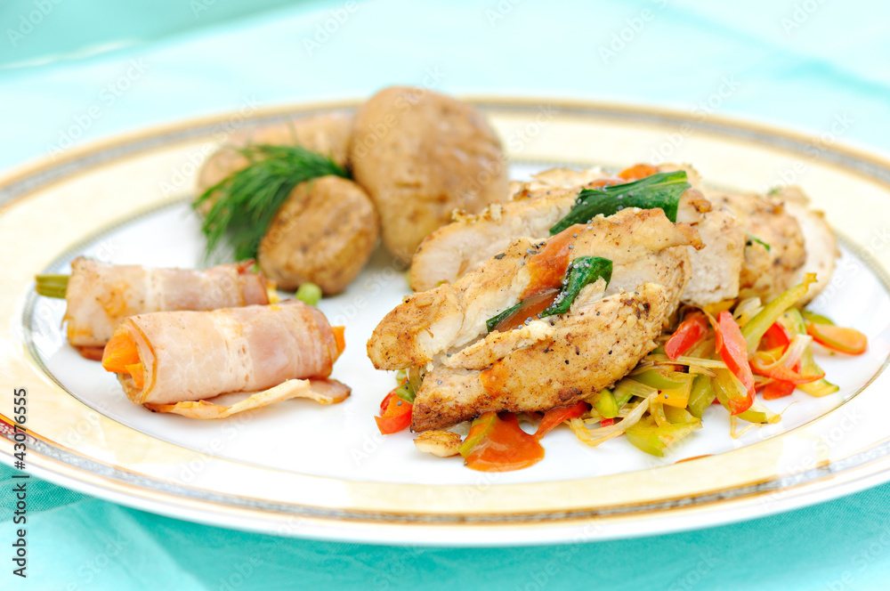 meal with prepared chicken meat, bacon rolls and vegetables