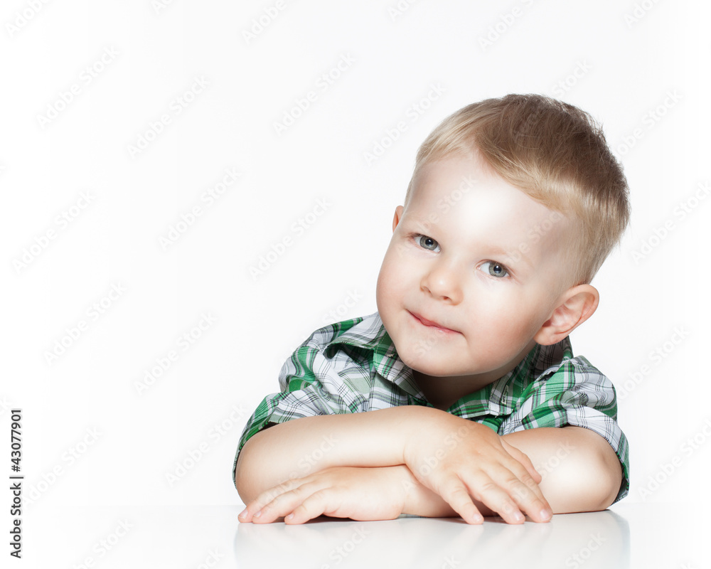 Portrait of a cute little boy smiling while sitting at table, Portrait of a cute little boy smiling while sitting at table,