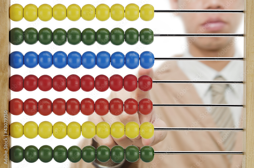 Businessman point finger on colourful abacus Businessman point finger on colourful abacus