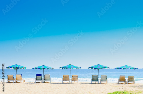 Beach chairs and with umbrella on the beach