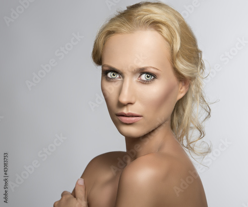 Portrait of pretty blonde woman she looks in to the lens