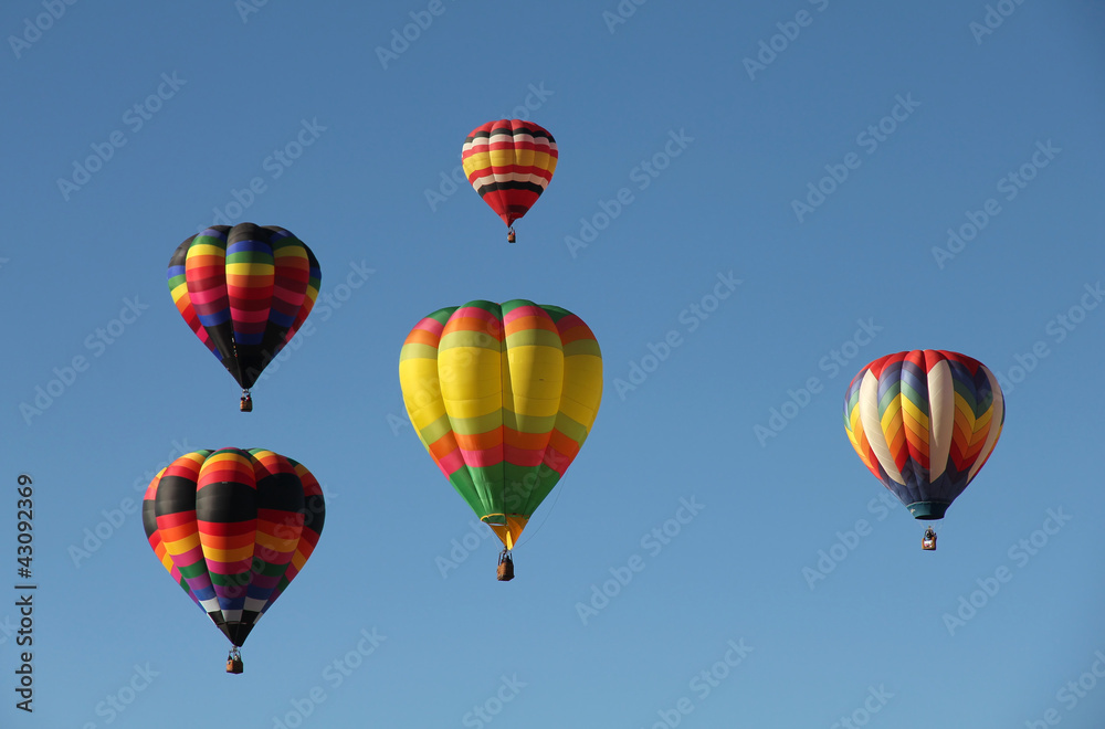 Colorful Hot Air Balloons Floating Against a Blue Sky Colorful Hot Air Balloons Floating Against a Blue Sky