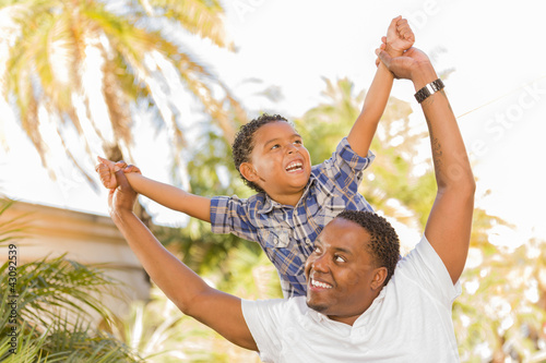 Mixed Race Father and Son Playing Piggyback