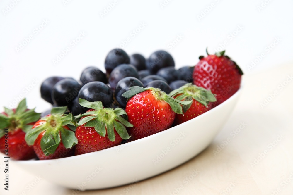 Full plate with strawberries and grapes Full plate with strawberries and grapes