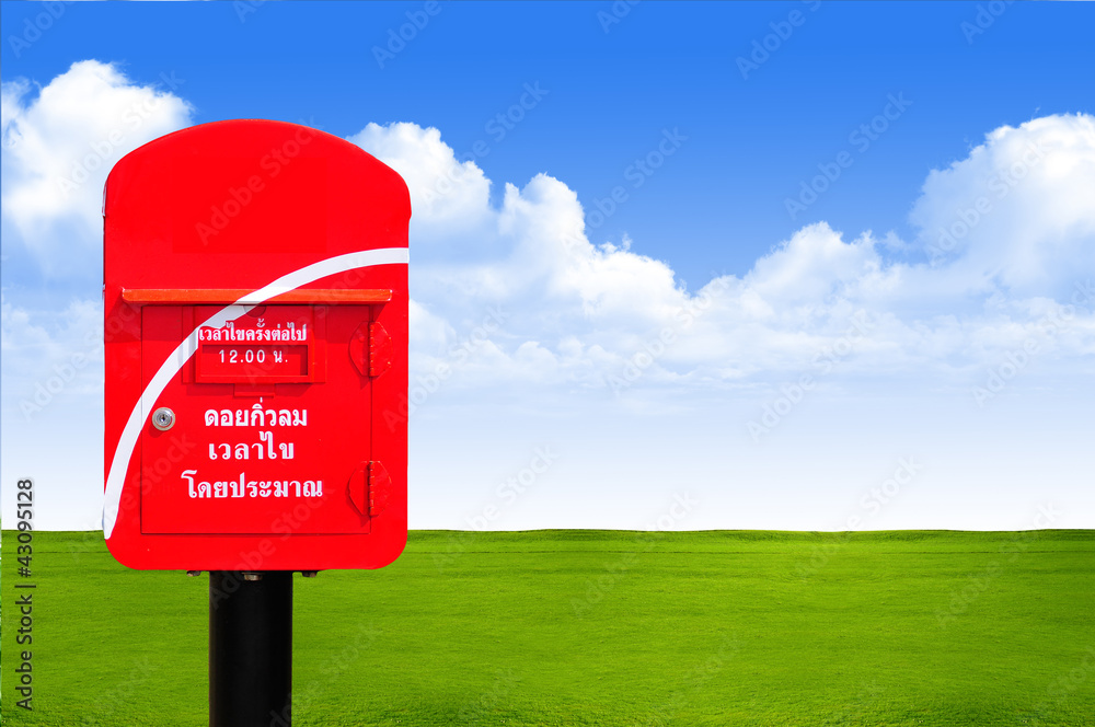 Red thailand post box on green grass and blue sky background Red thailand post box on green grass and blue sky background