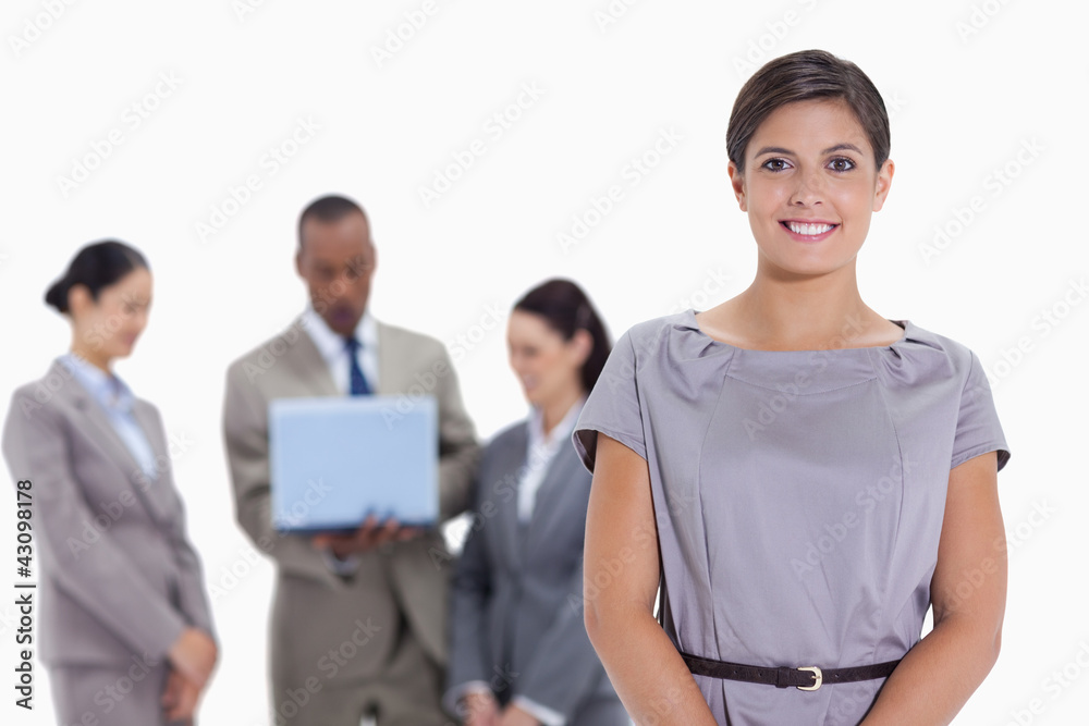 Woman business team in the background watching a laptop Woman business team in the background watching a laptop