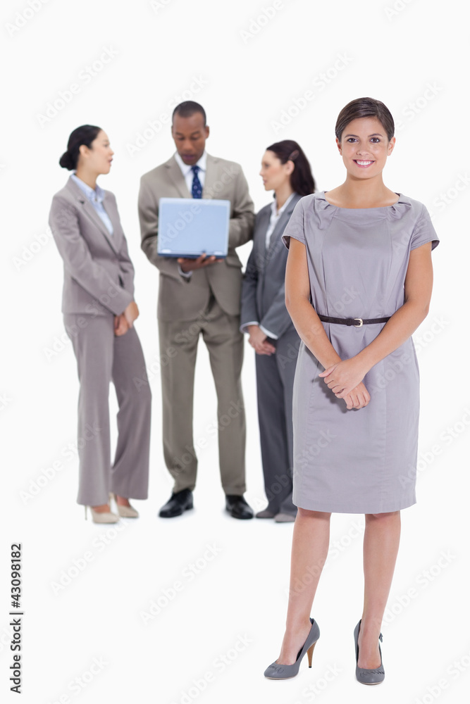 Woman holding her hands with co-workers talking in the backgroun Woman holding her hands with co-workers talking in the backgroun