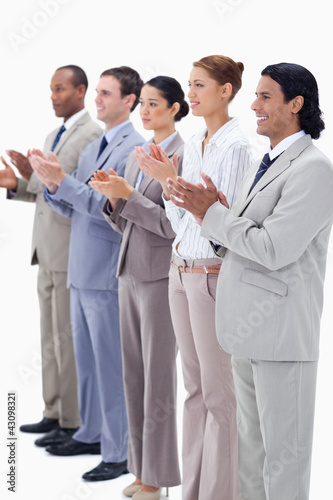 People dressed in suits smiling and applauding