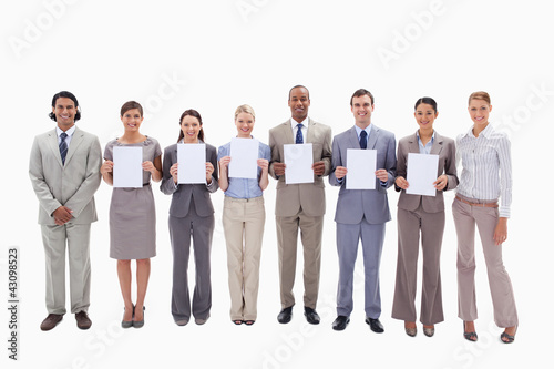 Happy business people holding six supports for letters
