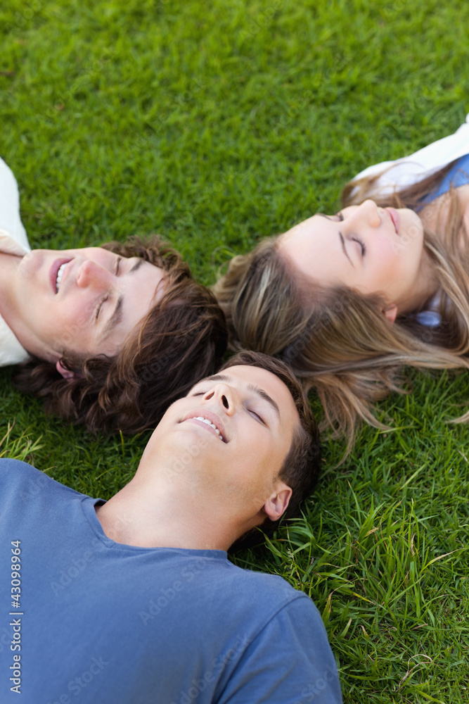 Three students lying together Three students lying together