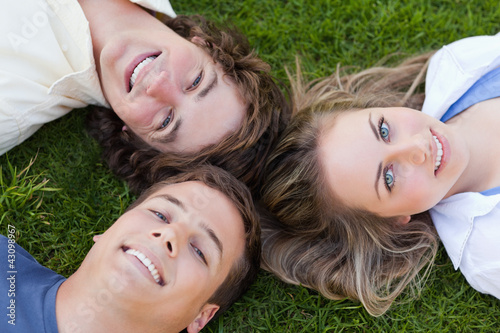 Close-up on three students lying together