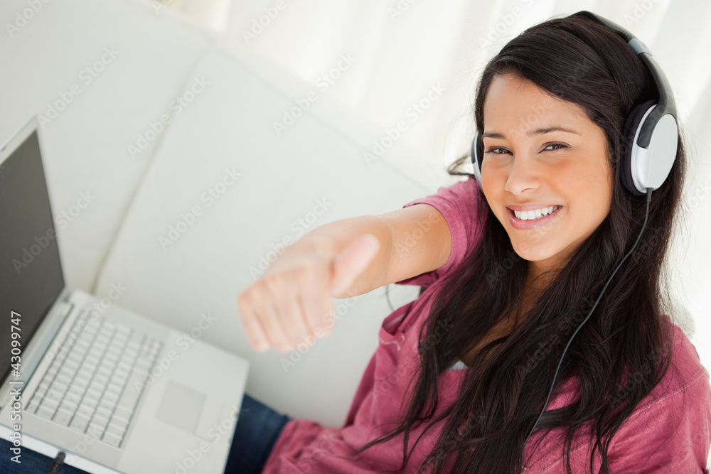 High-angle view of a student with a laptop the thumb-up High-angle view of a student with a laptop the thumb-up