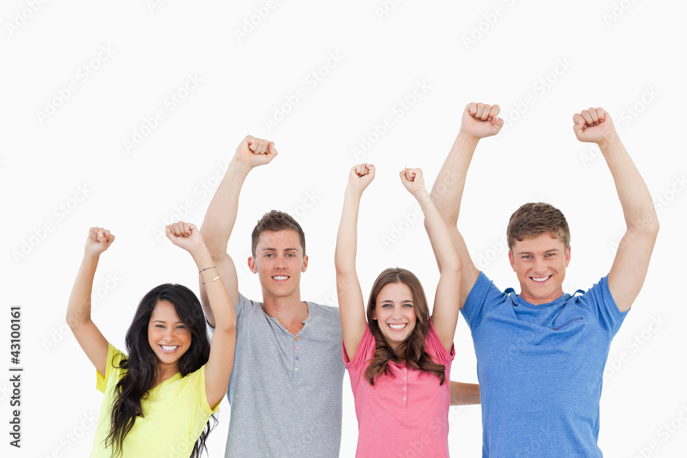 A smiling group of people looking at the camera and celebrating A smiling group of people looking at the camera and celebrating