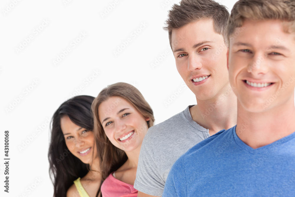 Four people standing one in front of the other with the girls he Four people standing one in front of the other with the girls he