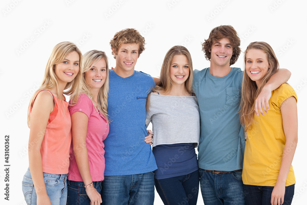 A group of friends smiling and holding each other A group of friends smiling and holding each other