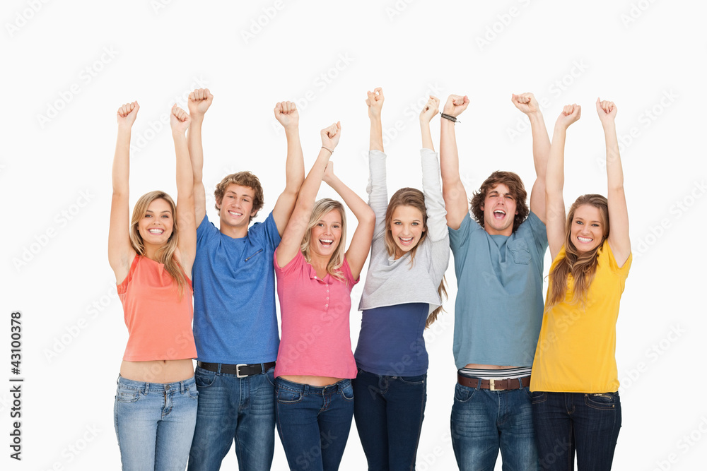 Smiling people raising hands up in the air Smiling people raising hands up in the air