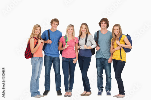 Smiling group with backpacks on as they smile © WavebreakmediaMicro