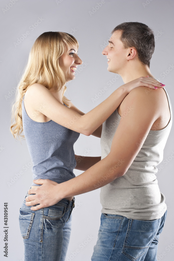 Young couple together on grey background Young couple together on grey background
