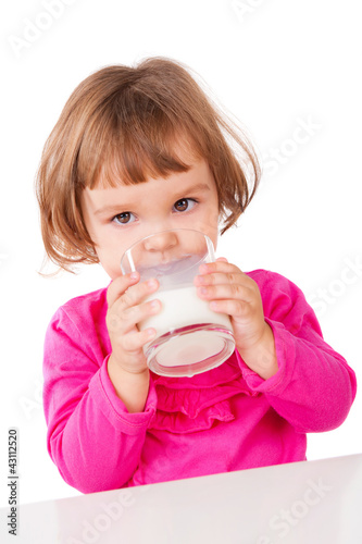 Little girl drinking milk, isolated on white
