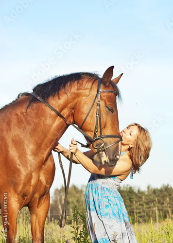 pretty women with her horsе in meadow