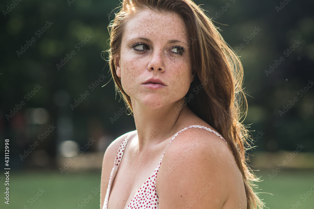 Beautiful red hair girl in a campus