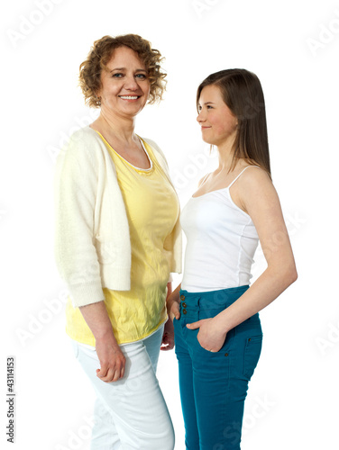 Pretty teenage girl looking at her modern mum