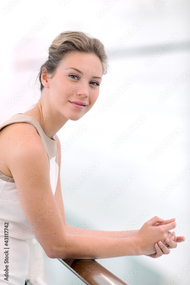 Beautiful blond businesswoman standing in hall Beautiful blond businesswoman standing in hall