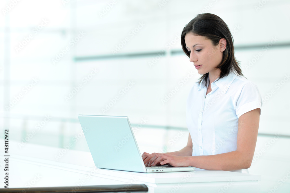 Office worker using laptop computer Office worker using laptop computer