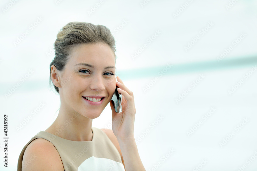 Blond executive woman talking on mobile phone
