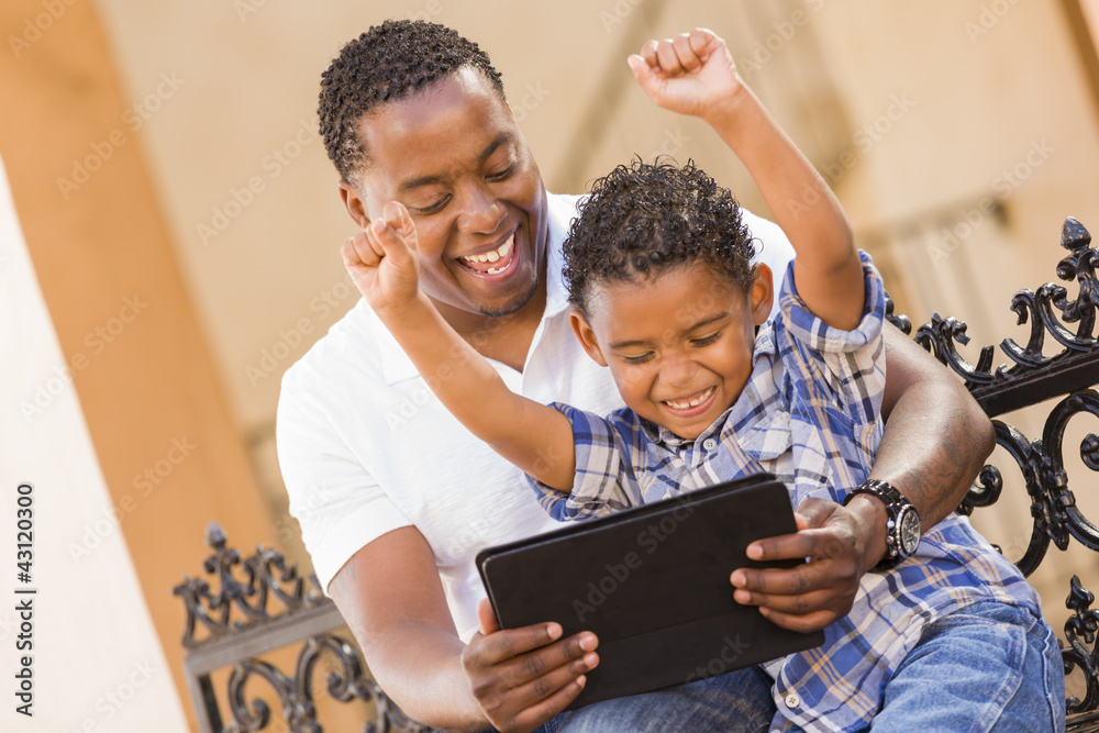 Mixed Race Father and Son Using Touch Pad Computer Tablet Mixed Race Father and Son Using Touch Pad Computer Tablet