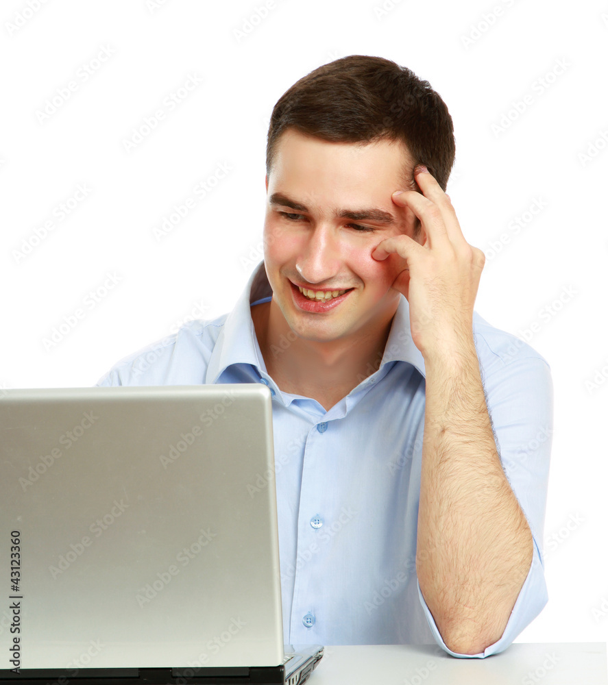 A young man sitting in front of a laptop A young man sitting in front of a laptop
