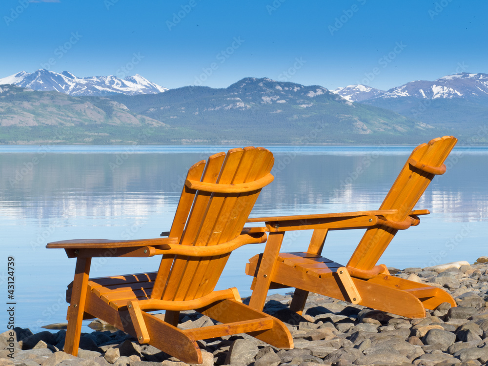 Wooden deckchairs overlooking scenic Lake Laberge Wooden deckchairs overlooking scenic Lake Laberge