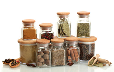 Fototapete Gewürze jars and wooden spoons with spices isolated on white  © Africa Studio