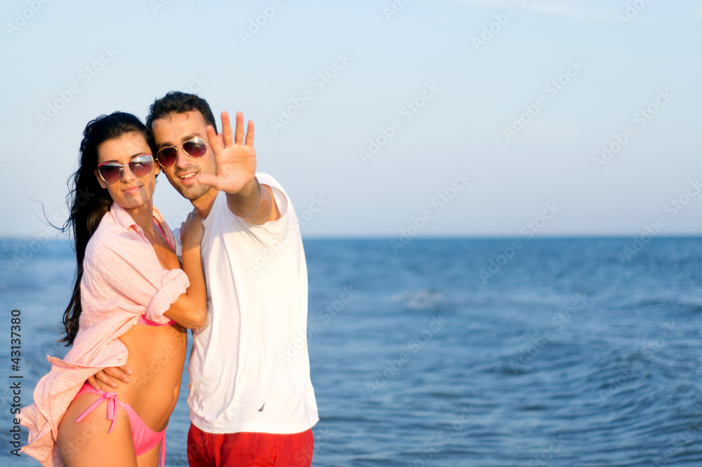 Happy couple at the beach in a playful mood Happy couple at the beach in a playful mood