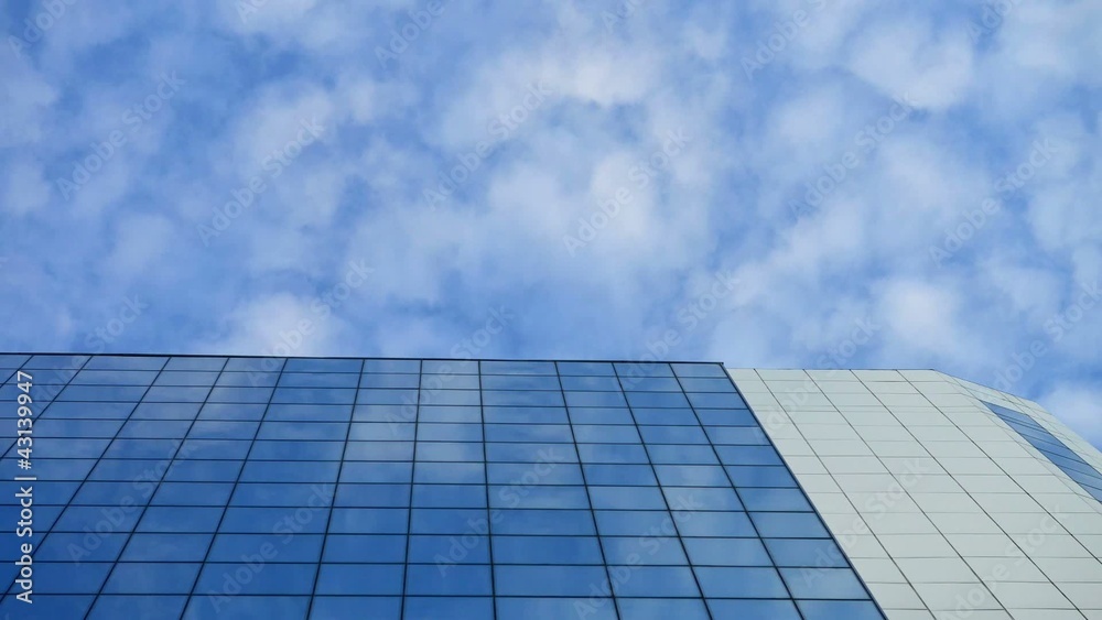 Time lapse moving clouds reflected in windows of the skyscraper Time lapse moving clouds reflected in windows of the skyscraper