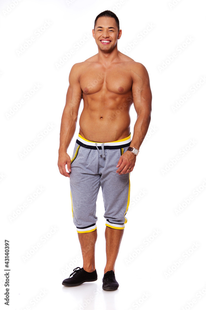 Portrait of muscle man posing in studio in shorts