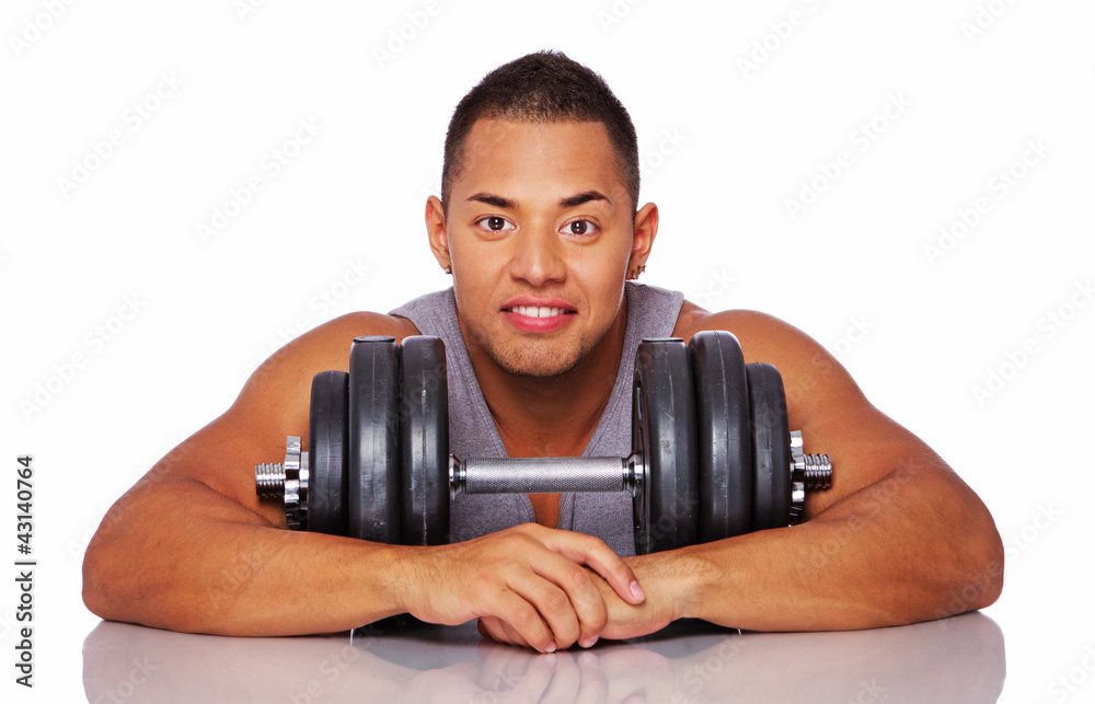 Portrait of muscle man posing in studio with dumbbells Portrait of muscle man posing in studio with dumbbells