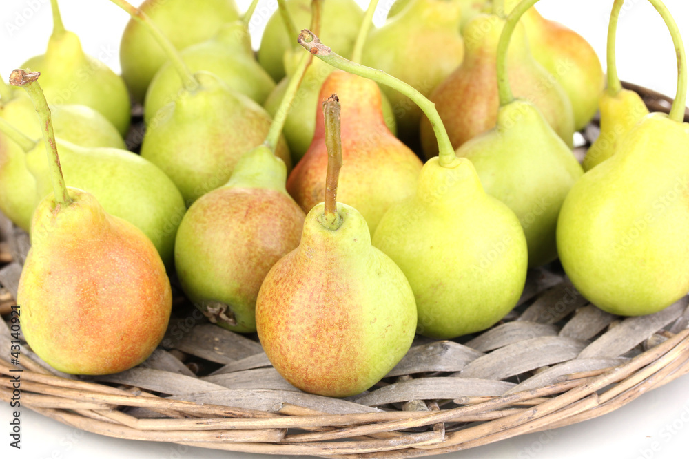 ripe pears on wicker mat isolated on white. ripe pears on wicker mat isolated on white.