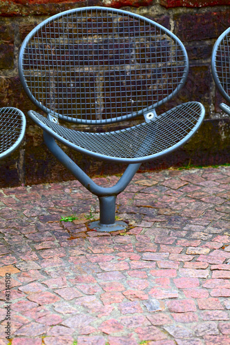 A public metal chair on the promenade