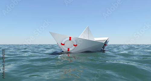 White paper boat floating in the sea water
