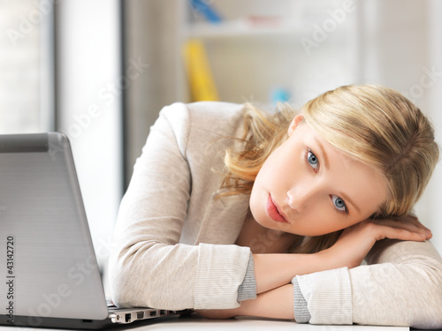 tired woman with laptop computer photo