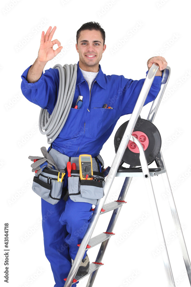 young electrician in studio looking happy young electrician in studio looking happy