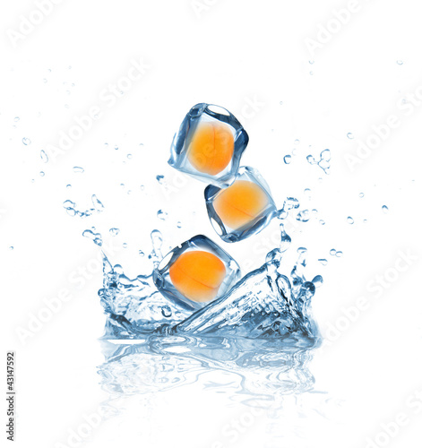 Apricot in ice cubes splashing into water © Lukas Gojda