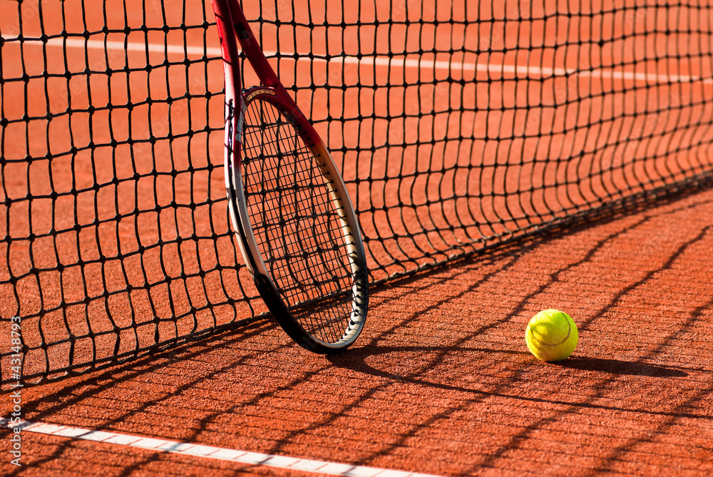 tennis racket on clay court