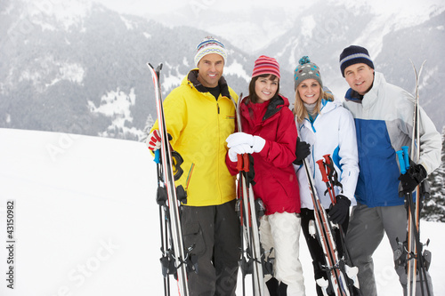 Group Of Middle Aged Couples On Ski Holiday In Mountains