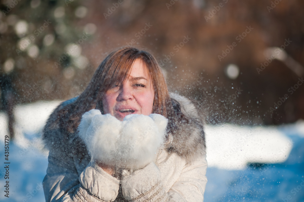 Beautiful woman blowing in the snow Beautiful woman blowing in the snow