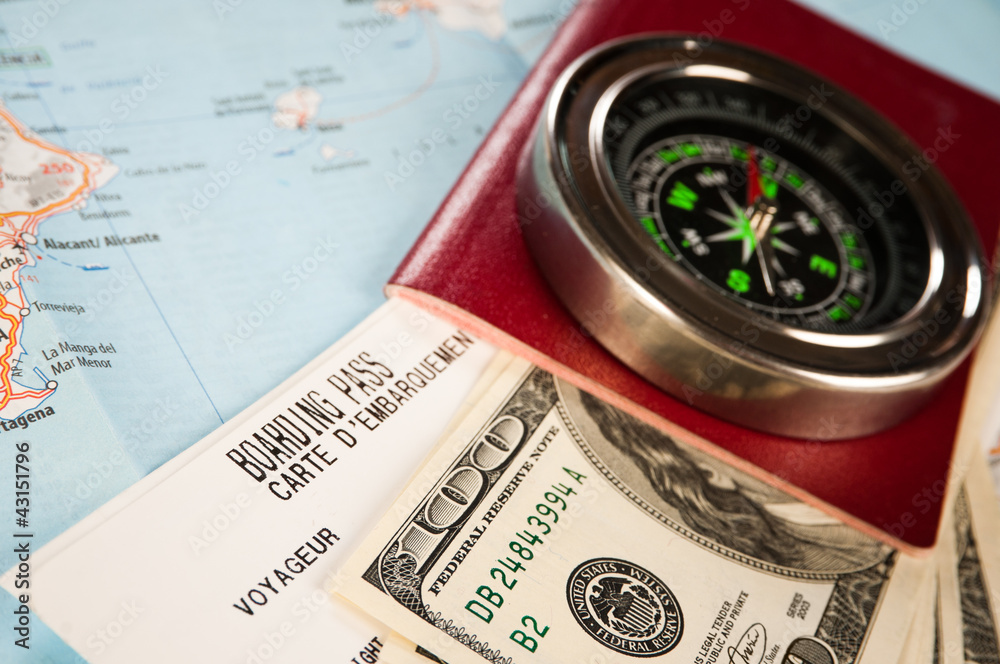 compass, money and passport with boarding pass compass, money and passport with boarding pass