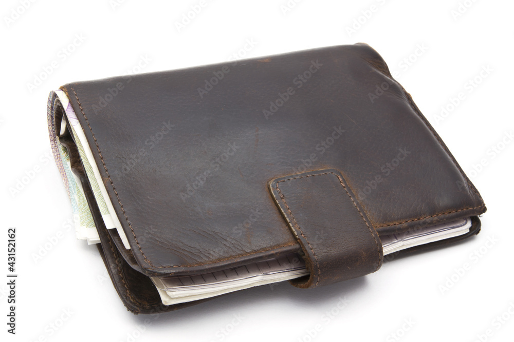 Old brown wallet with currency isolated on white Old brown wallet with currency isolated on white