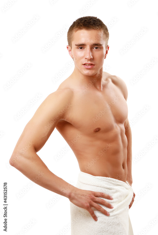 A nude young man covering himself with a towel